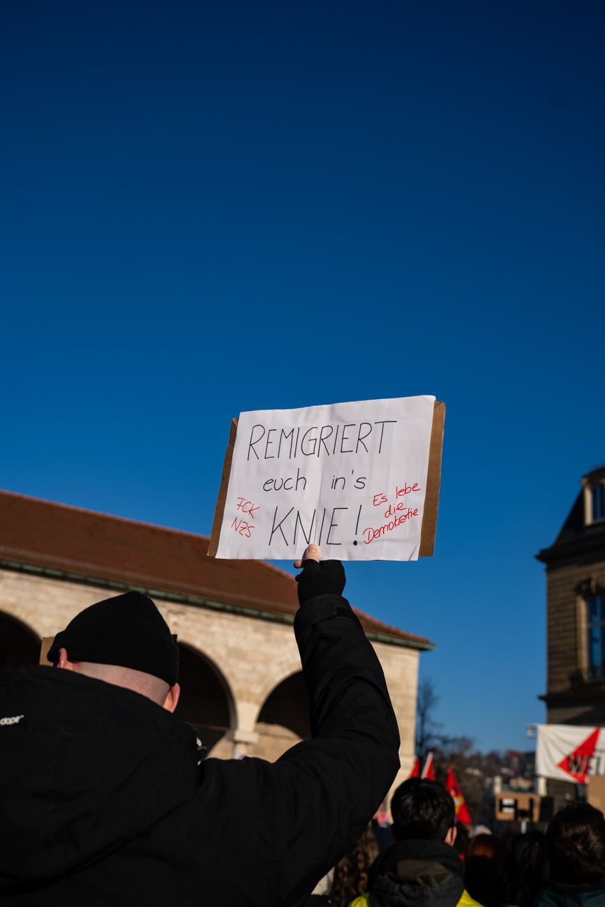 man with banner in protesting crowd